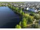 Beautiful aerial view of a lakeside neighborhood with many well maintained homes and lush landscaping at 13618 Briand Ave, Orlando, FL 32827