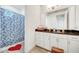 Bright bathroom with shower, large mirror, white cabinets, and a granite countertop at 13618 Briand Ave, Orlando, FL 32827