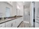 Bathroom offers dual sinks, granite counters, modern fixtures, and tiled walk-in shower at 13618 Briand Ave, Orlando, FL 32827