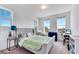 Bright bedroom with large windows, light walls, gray bed frame, desk, and ample natural light at 13618 Briand Ave, Orlando, FL 32827