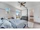 Bright bedroom features a four-poster bed, ceiling fan, plush rug, and lots of light at 13618 Briand Ave, Orlando, FL 32827