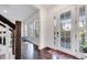 Bright entryway with hardwood floors and view to dining area with natural light at 13618 Briand Ave, Orlando, FL 32827