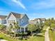 Charming blue two-story home featuring a well-manicured front yard with lush landscaping at 13618 Briand Ave, Orlando, FL 32827