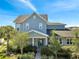 Charming two-story home with blue siding, a well-manicured lawn, and professional landscaping at 13618 Briand Ave, Orlando, FL 32827
