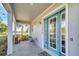 Inviting front porch with stylish blue door and ample space for outdoor seating at 13618 Briand Ave, Orlando, FL 32827