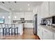 Bright kitchen boasts stainless appliances, white cabinets, granite counters, and hardwood flooring at 13618 Briand Ave, Orlando, FL 32827
