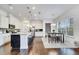 Modern kitchen with stainless steel appliances, a large island, and a dining area at 13618 Briand Ave, Orlando, FL 32827