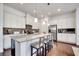 Bright kitchen boasts stainless appliances, white cabinets, granite counters, and hardwood flooring at 13618 Briand Ave, Orlando, FL 32827
