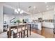 Open-concept kitchen and dining area featuring stainless appliances, granite counters and hardwood flooring at 13618 Briand Ave, Orlando, FL 32827
