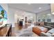 Spacious living room with open layout to kitchen and dining, hardwood floors, and natural light at 13618 Briand Ave, Orlando, FL 32827