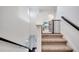 Carpeted staircase with stained wood handrail provides access to the upper level at 13618 Briand Ave, Orlando, FL 32827