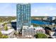 Aerial view of condo building with lake and city skyline in the background at 150 E Robinson St # 4A, Orlando, FL 32801