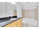 Bright bathroom featuring a modern vanity with black countertop and a bathtub with tiled surround at 150 E Robinson St # 4A, Orlando, FL 32801