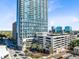 Exterior daytime view of a condo building showing architectural details and parking at 150 E Robinson St # 4A, Orlando, FL 32801