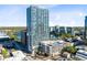View of high-rise building featuring cityscape, lake views, pool, and convenient parking at 150 E Robinson St # 4A, Orlando, FL 32801