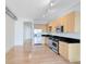 Open concept kitchen featuring stainless steel appliances, wood cabinets, and a black countertop at 150 E Robinson St # 4A, Orlando, FL 32801