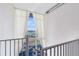 Scenic view through large windows from the staircase, enhanced by sheer white curtains at 150 E Robinson St # 4A, Orlando, FL 32801