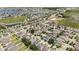 Aerial view of a home in a subdivision with mature trees, a pond, and beautiful lake views at 16753 Gullfloss Ter, Winter Garden, FL 34787