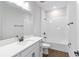 Bathroom showcasing a white vanity with dark fixtures and a bathtub with tile surround at 16753 Gullfloss Ter, Winter Garden, FL 34787