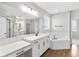Spacious bathroom features double vanity, large mirror and a soaking tub at 16753 Gullfloss Ter, Winter Garden, FL 34787