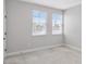 Bedroom featuring carpeted floors, two windows and neutral walls for a bright and versatile living space at 16753 Gullfloss Ter, Winter Garden, FL 34787