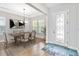 Bright dining room featuring a modern chandelier, large windows, and light wood flooring at 16753 Gullfloss Ter, Winter Garden, FL 34787