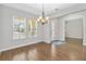 Bright entryway featuring wood floors, a decorative front door, a chandelier and large windows at 16753 Gullfloss Ter, Winter Garden, FL 34787