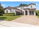 Stunning two-story home boasts a tile roof, brick driveway, manicured landscaping, and an attached two-car garage at 16753 Gullfloss Ter, Winter Garden, FL 34787