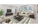 Bright living room featuring large windows, neutral furniture, and a stylish rug at 16753 Gullfloss Ter, Winter Garden, FL 34787