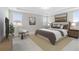 Comfortable main bedroom featuring a tray ceiling, and natural light at 16753 Gullfloss Ter, Winter Garden, FL 34787