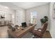 Home office featuring a large wooden desk, comfortable chair, and ample natural light at 16753 Gullfloss Ter, Winter Garden, FL 34787