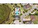 Aerial view of a community pool featuring an outdoor lounge area and nearby community amenities at 16753 Gullfloss Ter, Winter Garden, FL 34787