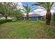 Spacious backyard with palm trees, lush greenery, and potential for outdoor activities at 1740 Cherry Ridge Dr, Lake Mary, FL 32746