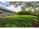 Expansive backyard featuring lush green lawn, mature landscaping, and privacy hedges at 1740 Cherry Ridge Dr, Lake Mary, FL 32746
