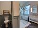 Contemporary bathroom featuring glass shower, soaking tub, and a decorative toilet room at 1740 Cherry Ridge Dr, Lake Mary, FL 32746
