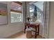 Bedroom table with a potted flower arrangement, window, and neutral striped curtains at 1740 Cherry Ridge Dr, Lake Mary, FL 32746