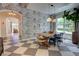 Elegant dining room featuring modern pendant lighting, stylish wallpaper, and lots of natural light at 1740 Cherry Ridge Dr, Lake Mary, FL 32746