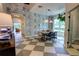 Elegant dining room with stylish wallpaper, modern lighting, and a view into other rooms at 1740 Cherry Ridge Dr, Lake Mary, FL 32746