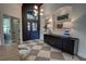 Grand entrance with modern light fixture, dark accent walls, and decorative cabinet with lamps at 1740 Cherry Ridge Dr, Lake Mary, FL 32746