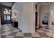 Stylish foyer featuring checkered tile flooring, unique light fixture, and view to the main bedroom at 1740 Cherry Ridge Dr, Lake Mary, FL 32746