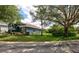Landscaped home exterior showcasing manicured lawn, vibrant garden beds, and mature trees at 1740 Cherry Ridge Dr, Lake Mary, FL 32746
