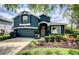 Charming two-story home with a blue exterior, beautiful landscaping, and well-manicured lawn at 1740 Cherry Ridge Dr, Lake Mary, FL 32746