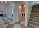 Hallway with a staircase, and arched entryway to the kitchen, and laundry area at 1740 Cherry Ridge Dr, Lake Mary, FL 32746