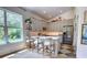 Bright kitchen with stone backsplash, breakfast bar, stainless steel appliances, gray cabinets, and wood floors at 1740 Cherry Ridge Dr, Lake Mary, FL 32746