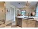 Bright kitchen connected to the living room features stone backsplash, and stainless steel appliances at 1740 Cherry Ridge Dr, Lake Mary, FL 32746