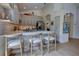 Bright kitchen with stone backsplash, breakfast bar, stainless steel appliances, gray cabinets, and wood floors at 1740 Cherry Ridge Dr, Lake Mary, FL 32746