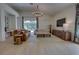 Bright living room with vaulted ceiling, modern chandelier, leather sofa and view to backyard pool at 1740 Cherry Ridge Dr, Lake Mary, FL 32746