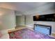 Spacious living room featuring a soft couch, decorative rug, and a large TV at 1740 Cherry Ridge Dr, Lake Mary, FL 32746
