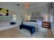 Cozy main bedroom featuring a king-size bed, elegant decor, and views of the surrounding landscape at 1740 Cherry Ridge Dr, Lake Mary, FL 32746