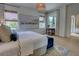 Bright main bedroom featuring neutral paint, light-colored wood floors, and woven shade window coverings at 1740 Cherry Ridge Dr, Lake Mary, FL 32746